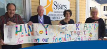 volunteers holding a sign
